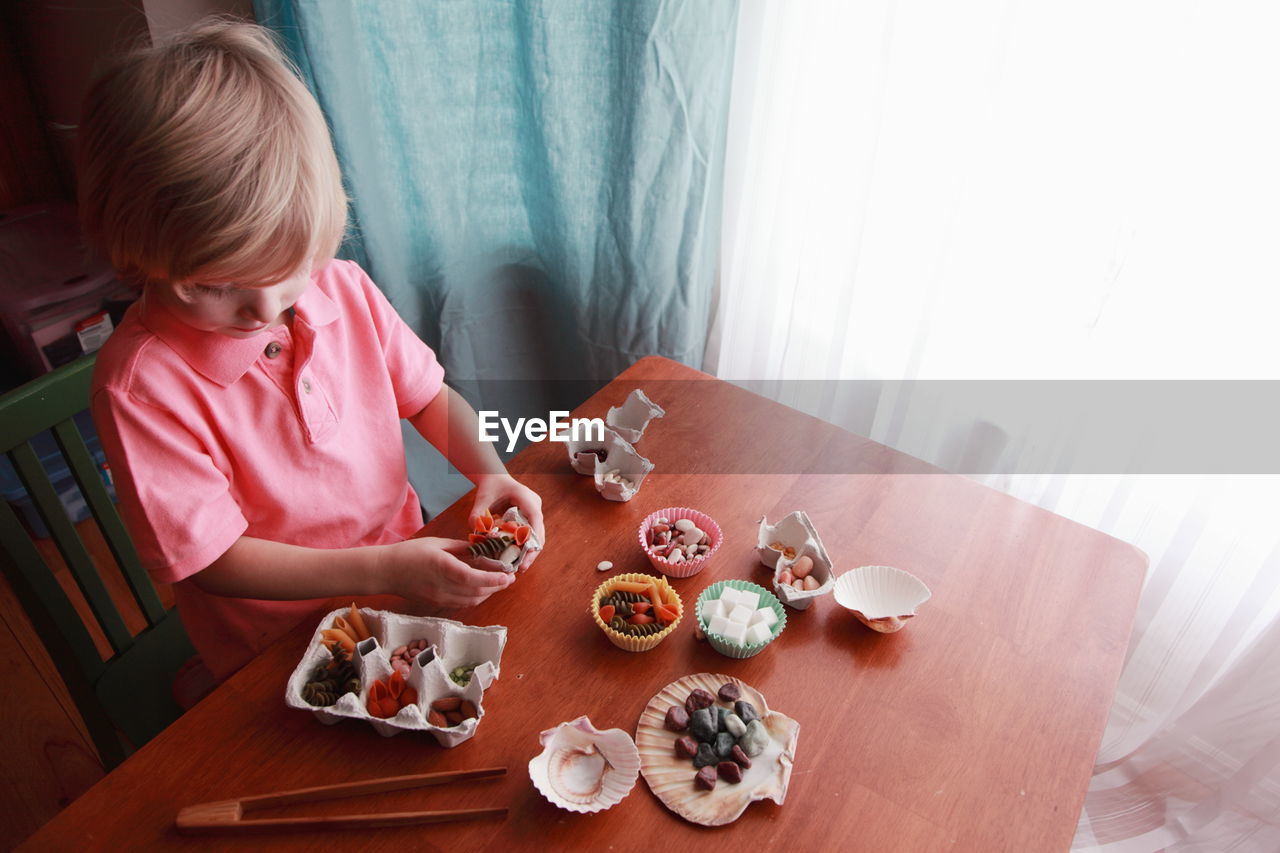 Rear view of woman sitting on chair