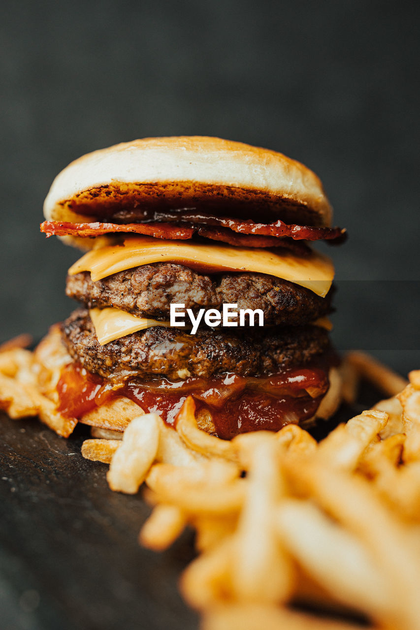 close-up of burger with french fries on table