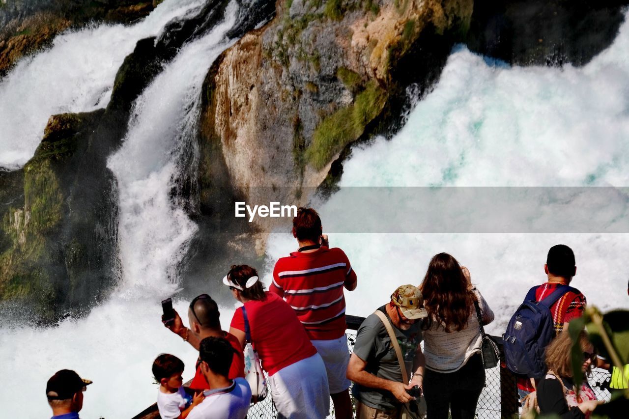 HIGH ANGLE VIEW OF PEOPLE ON ROCKS