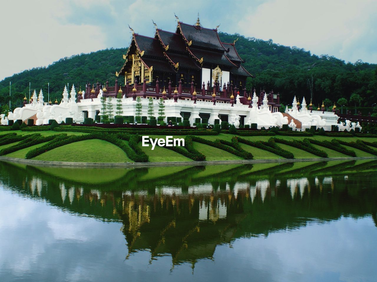 Royal pavilion reflecting in lake at chiang mai province