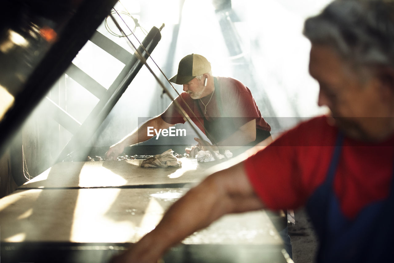 Workers cooking food in restaurant