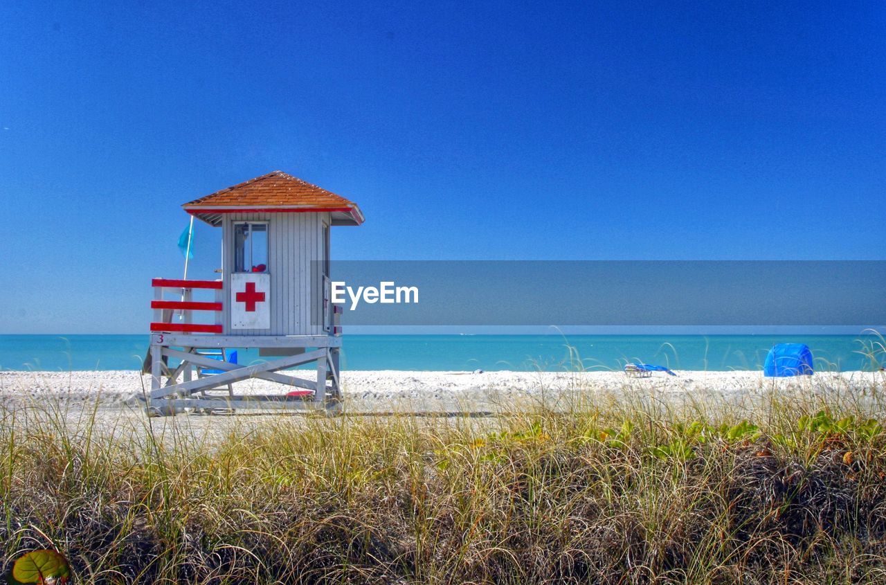 Lifeguard hut on beach against clear sky