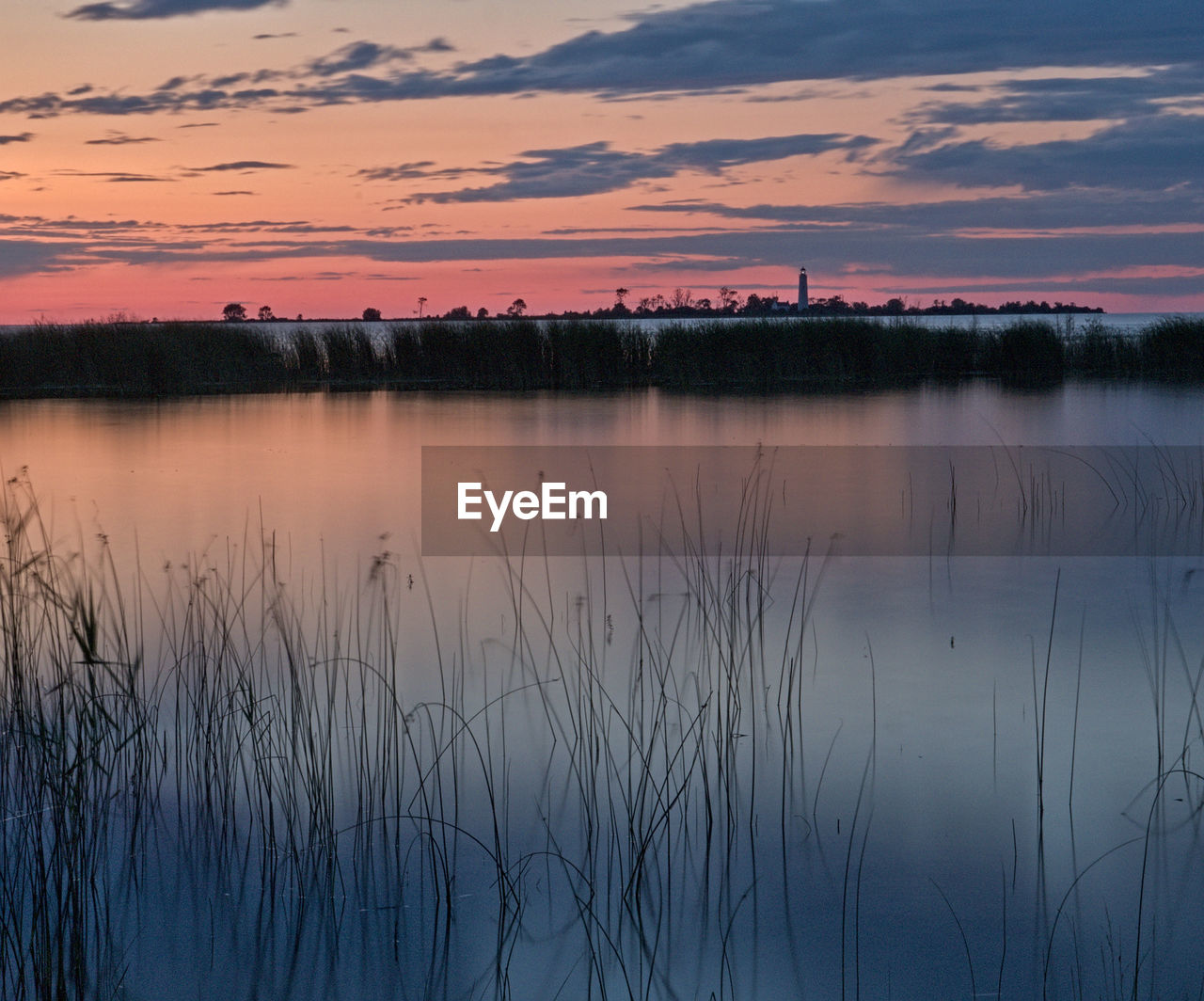 Scenic view of lake against sky during sunset