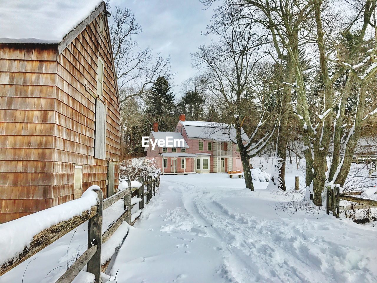 SNOW COVERED HOUSE AGAINST SKY