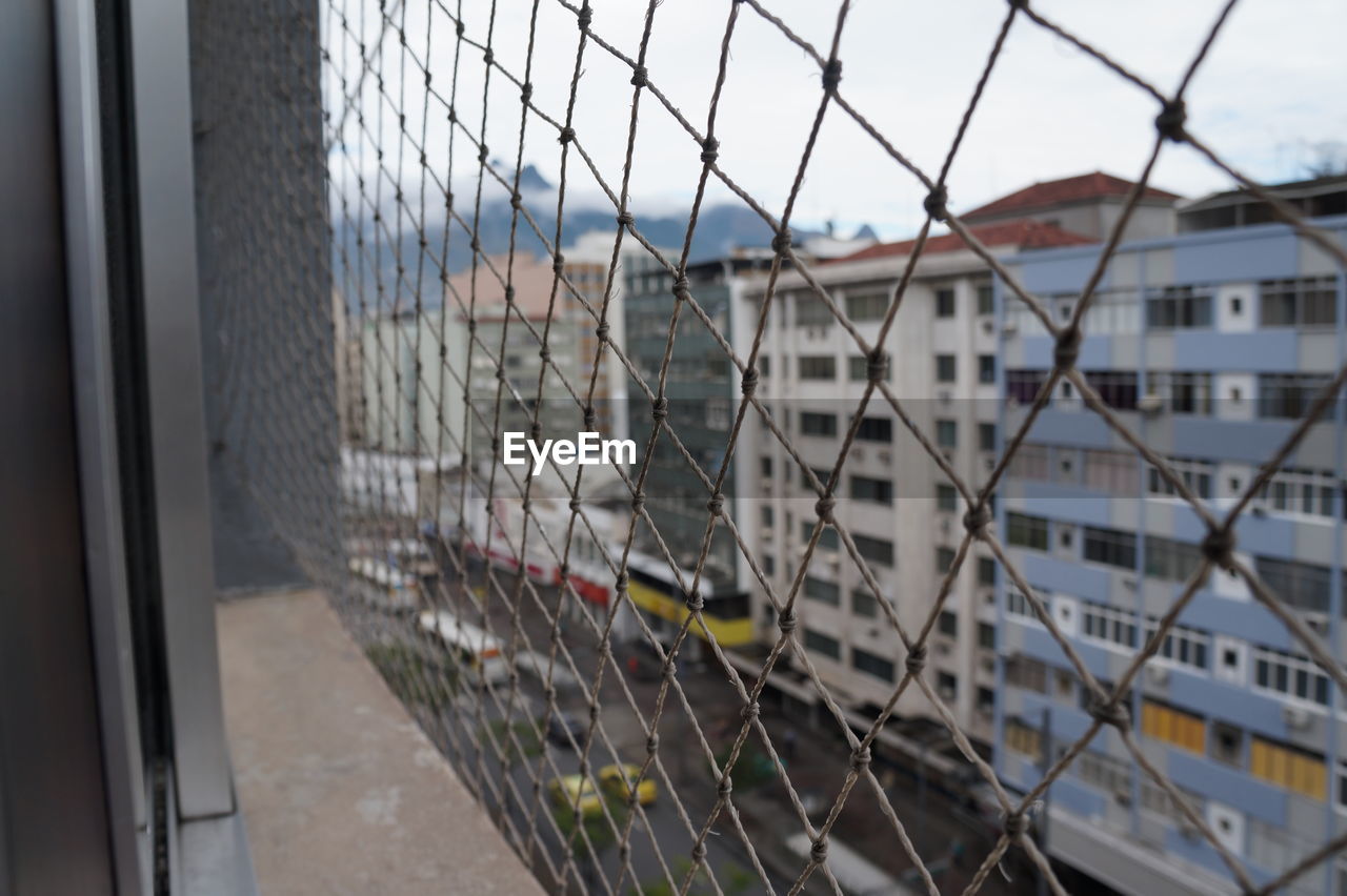 City seen through chainlink fence