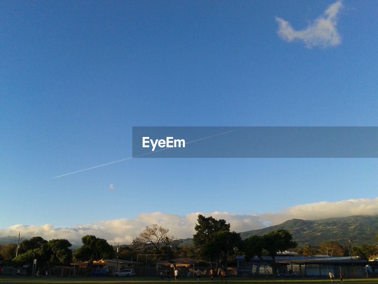 LOW ANGLE VIEW OF VAPOR TRAILS AGAINST BLUE SKY