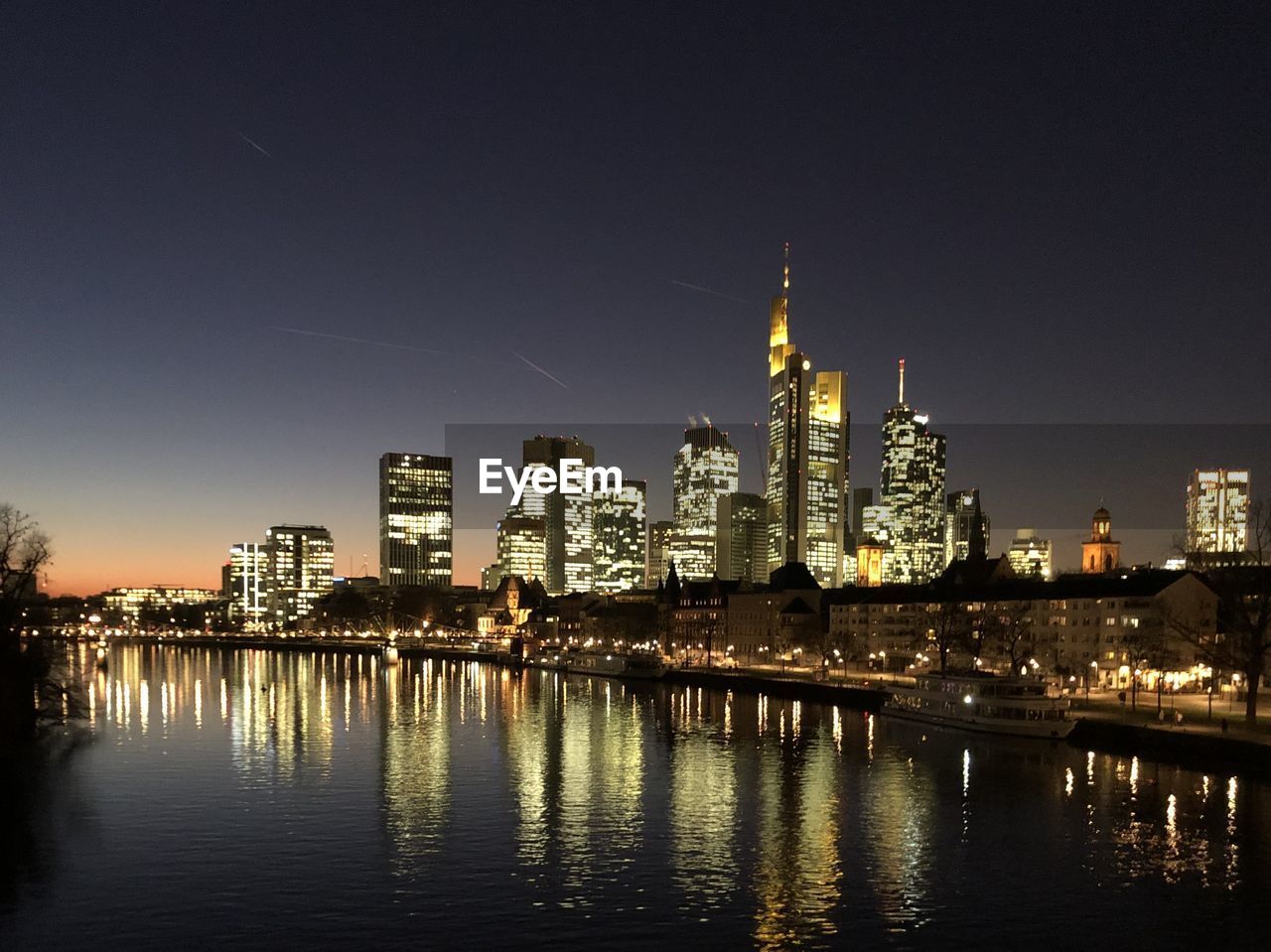 ILLUMINATED BUILDINGS AGAINST SKY AT NIGHT