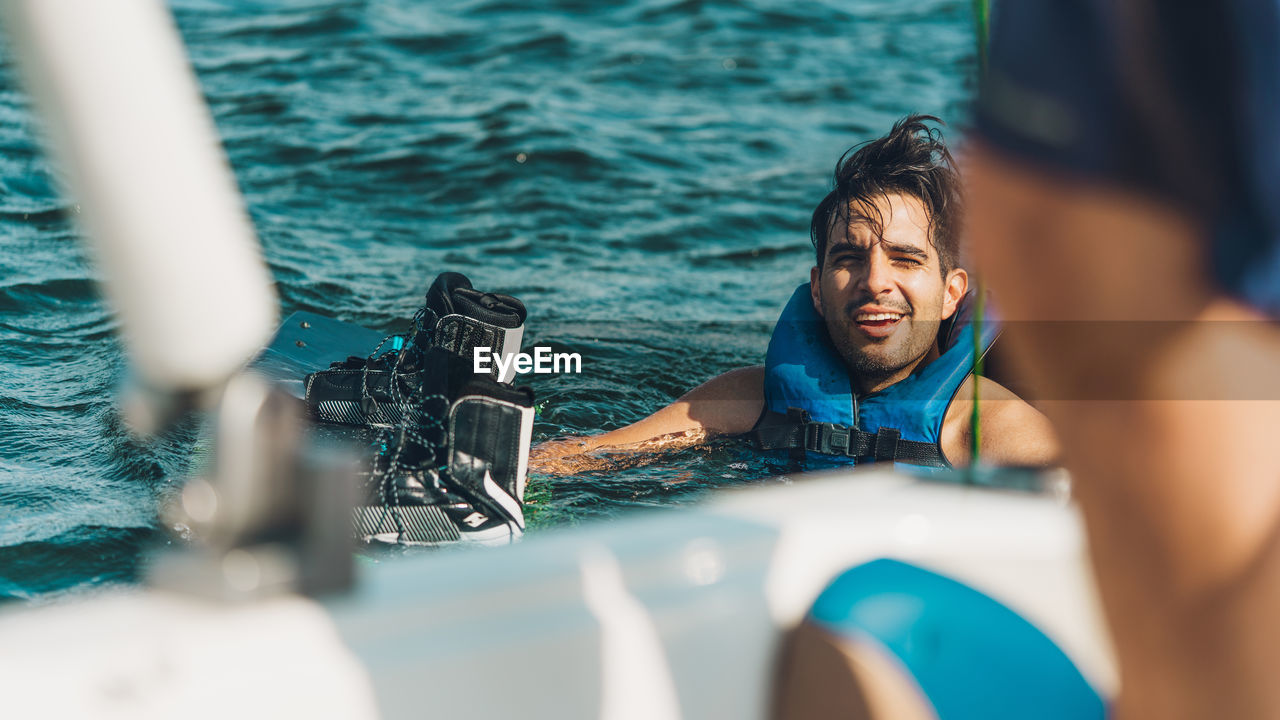 Man photographing against sea