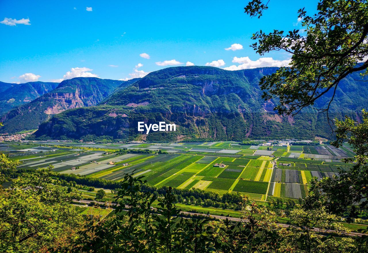 SCENIC VIEW OF AGRICULTURAL FIELD AGAINST MOUNTAINS
