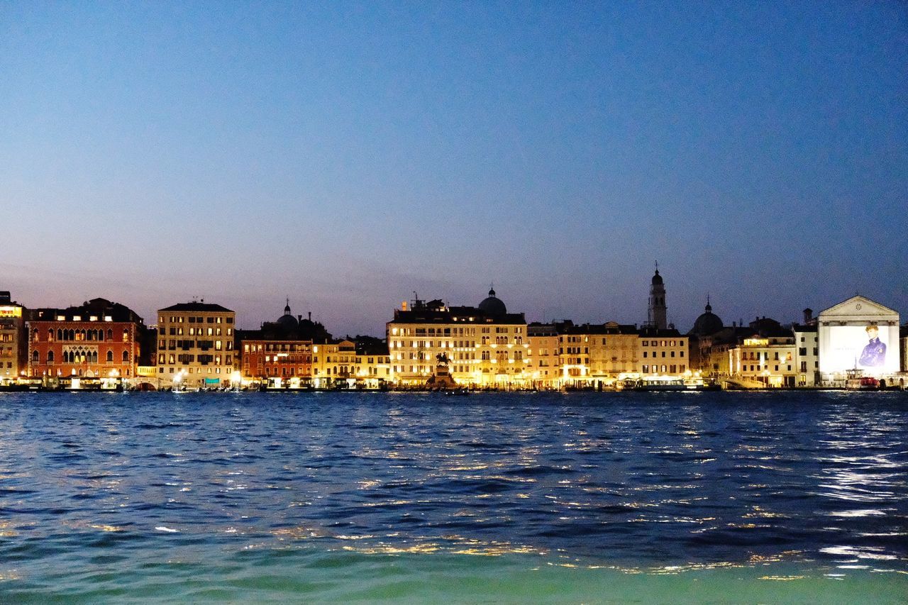 BUILDINGS LIT UP AT WATERFRONT