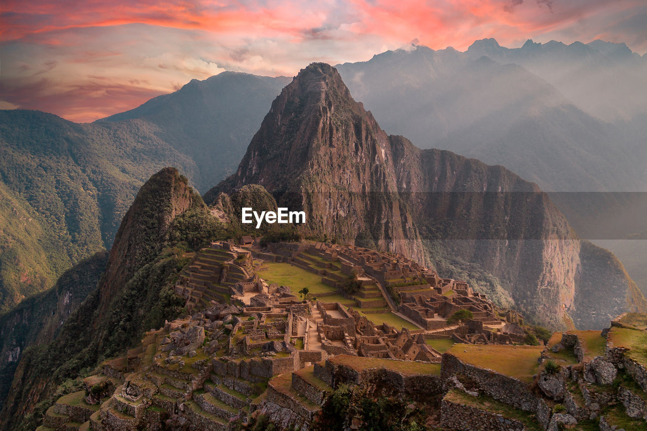 Scenic view of mountains against cloudy sky