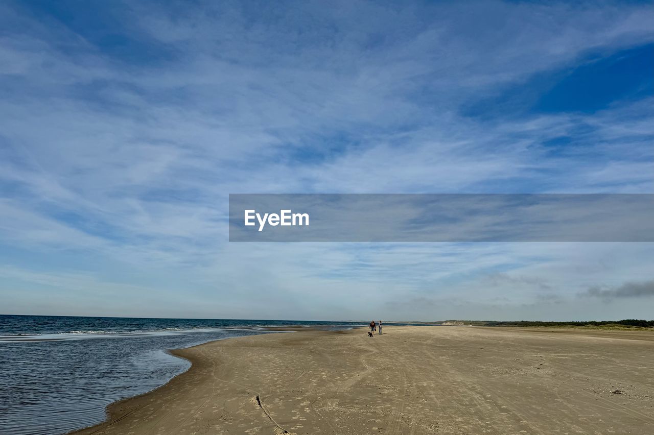 sky, land, water, horizon, beach, sea, scenics - nature, cloud, sand, shore, beauty in nature, nature, body of water, ocean, coast, tranquility, blue, environment, landscape, tranquil scene, horizon over water, travel destinations, day, travel, coastline, holiday, outdoors, wave, non-urban scene, tourism, trip, vacation, water's edge, natural environment, wind wave, urban skyline