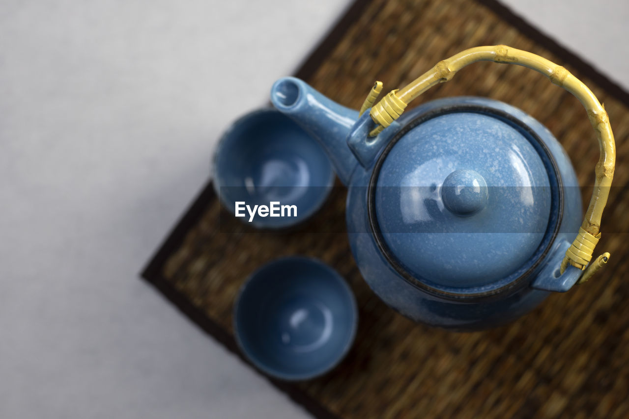 Blue ceramic teapot set on gray background drinking tea each day each person often has a different 