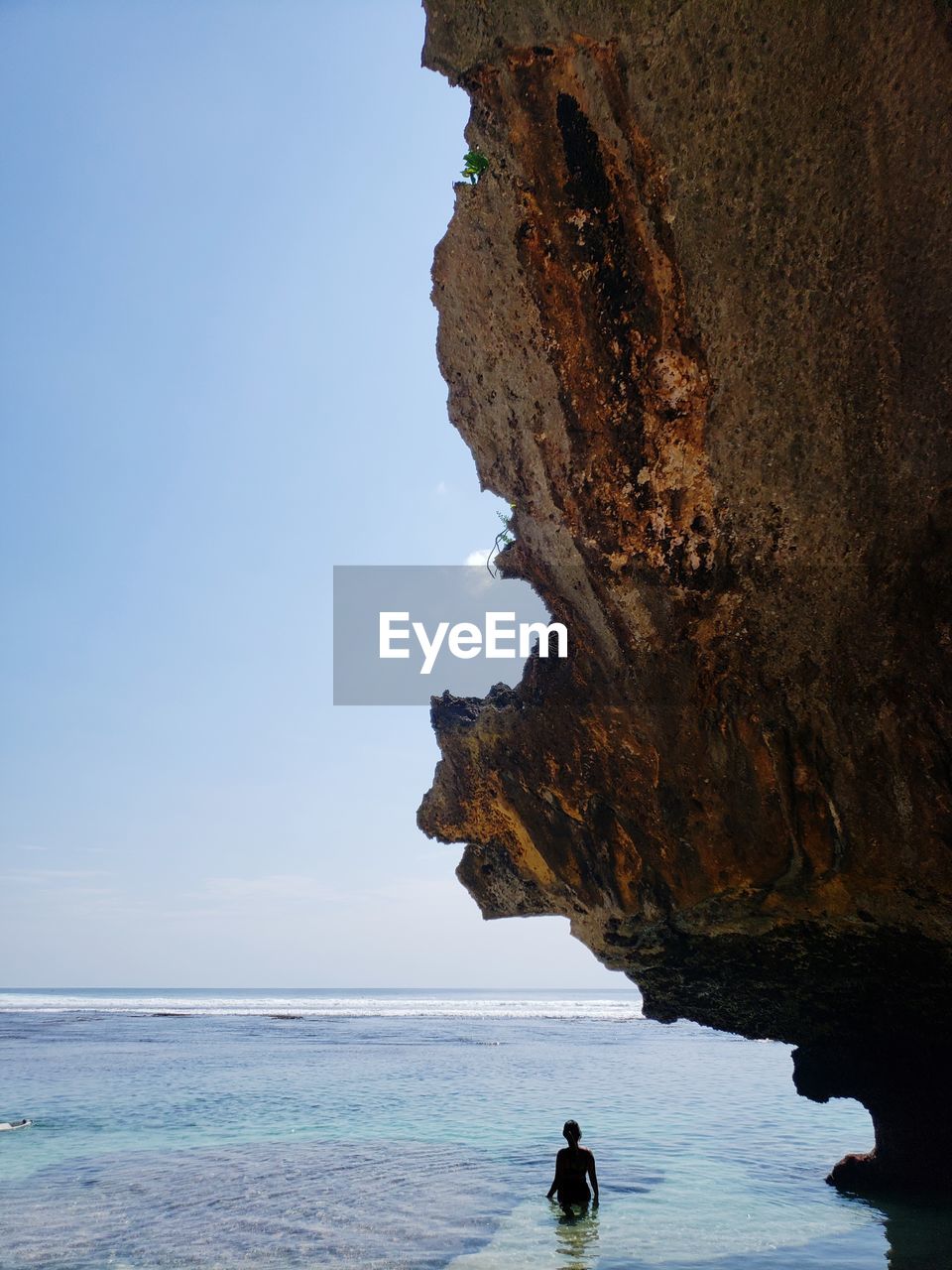 Rock formation on sea against sky