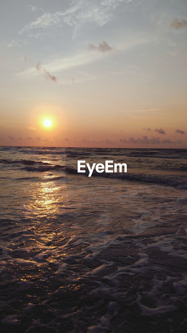 SCENIC VIEW OF BEACH DURING SUNSET