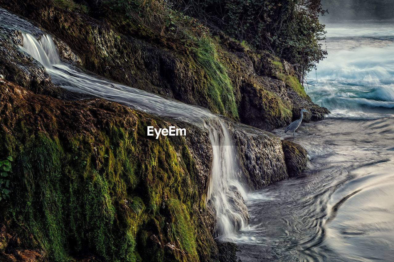 Long exposure photograph of the rhein falls with the laufen castle on the background.