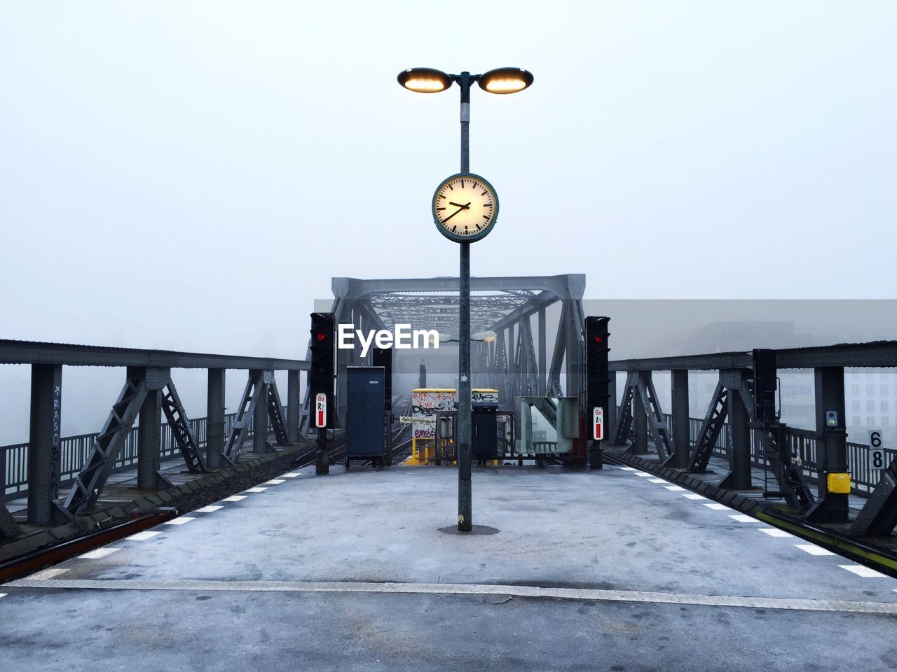 Railway bridge against sky in foggy weather