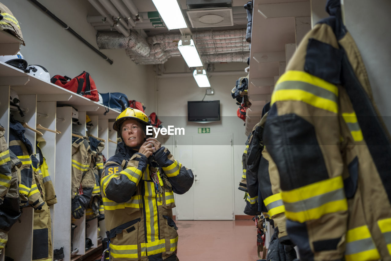 Female firefighter changing in locker