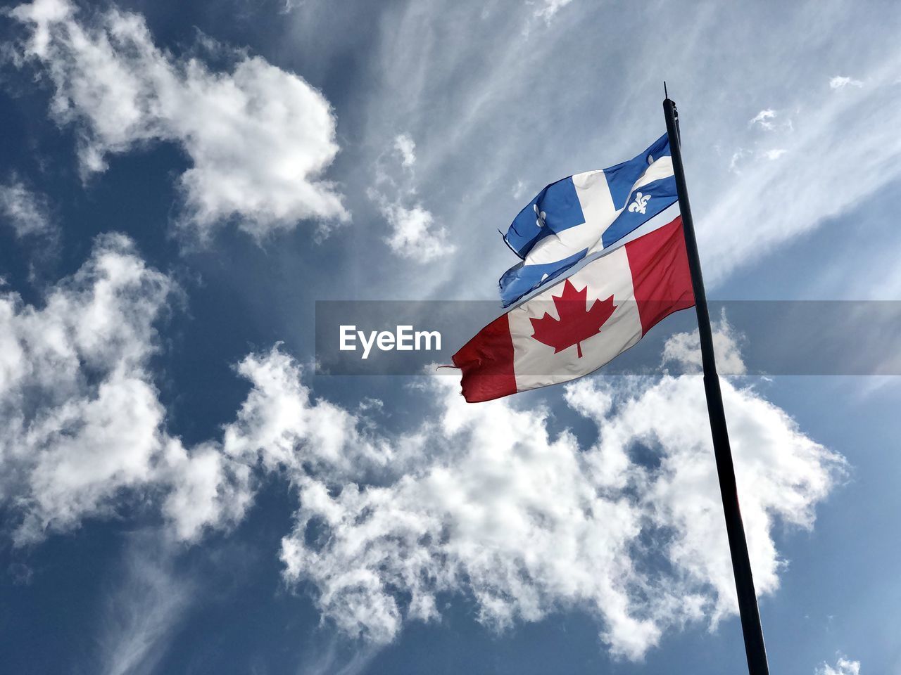 Low angle view of flags against sky