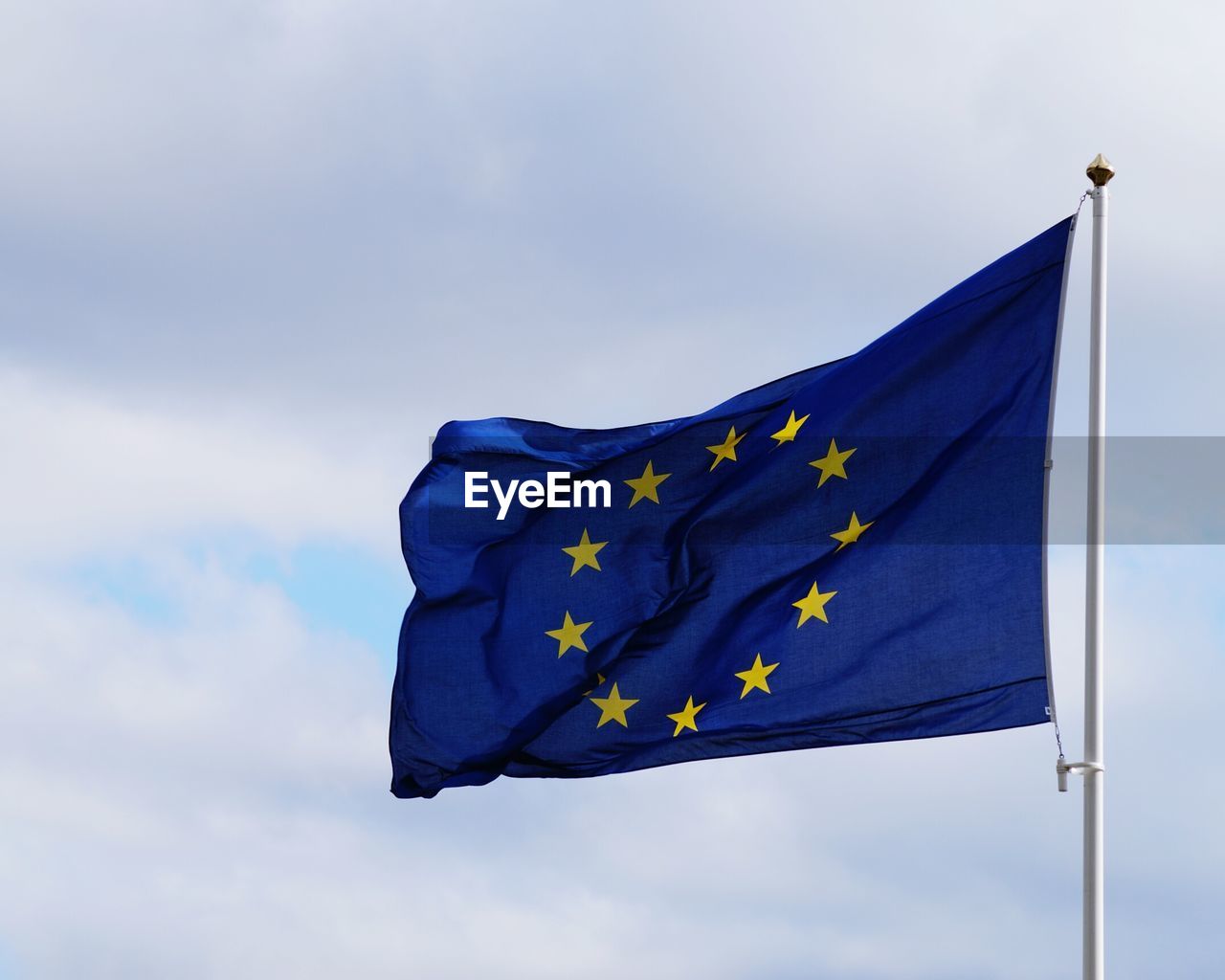 Low angle view of european union flag against blue sky
