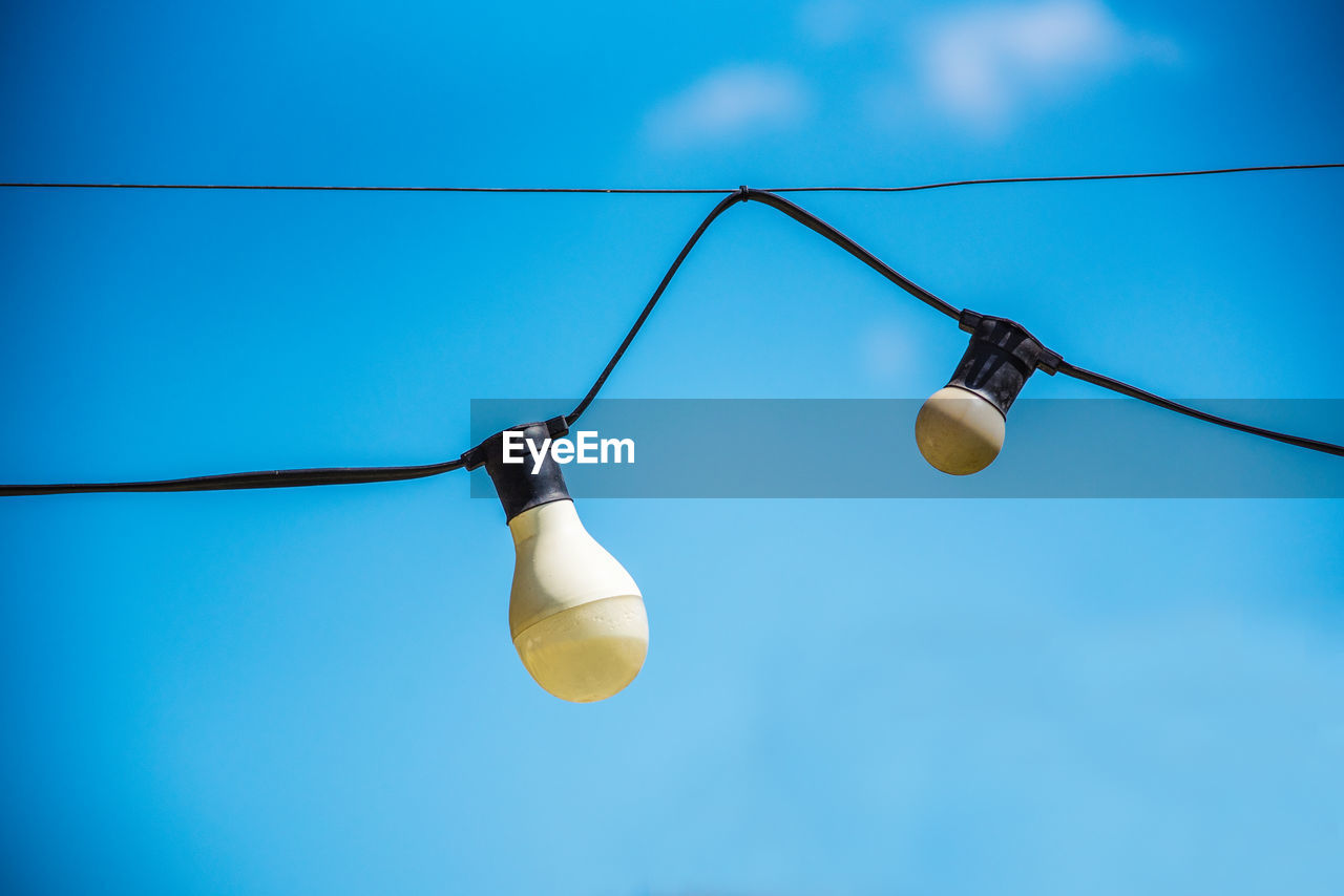 LOW ANGLE VIEW OF LIGHT BULB AGAINST SKY