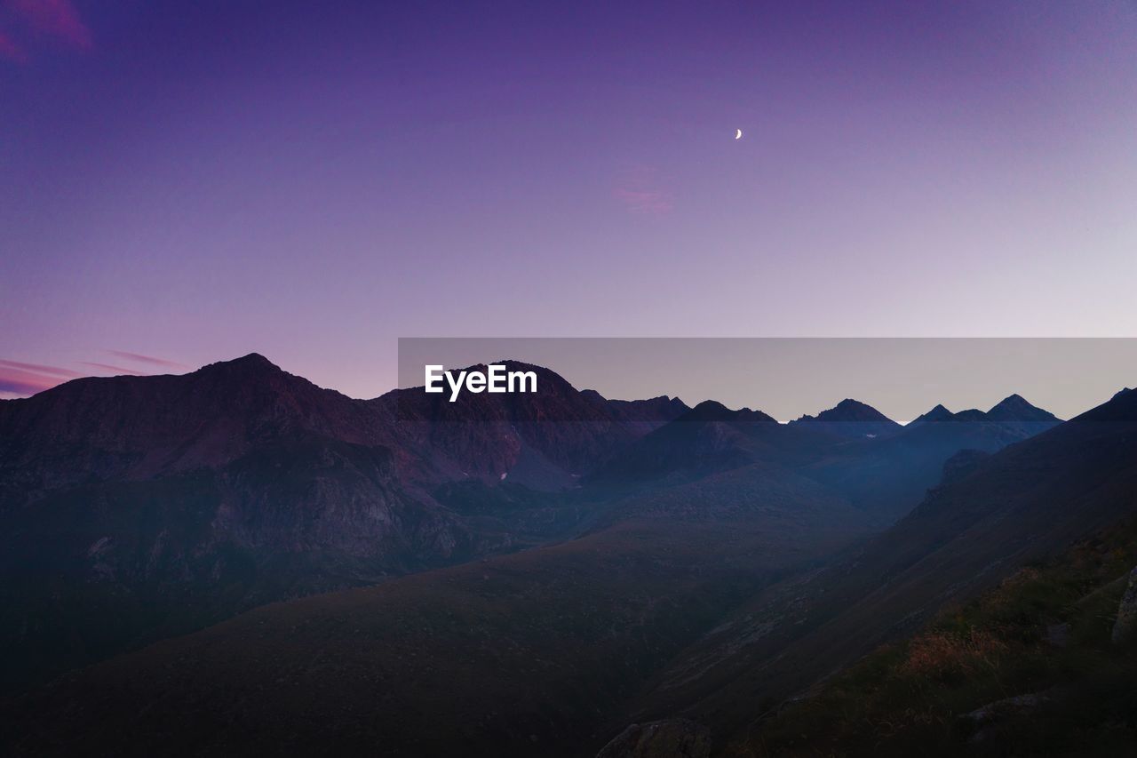 Scenic view of mountains against clear sky at night