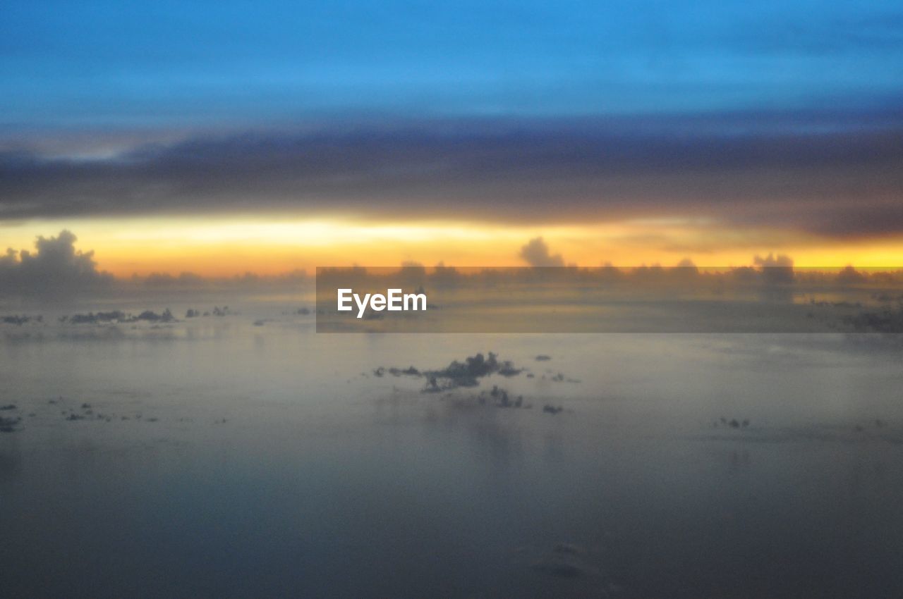 Scenic view of sea against sky at sunset