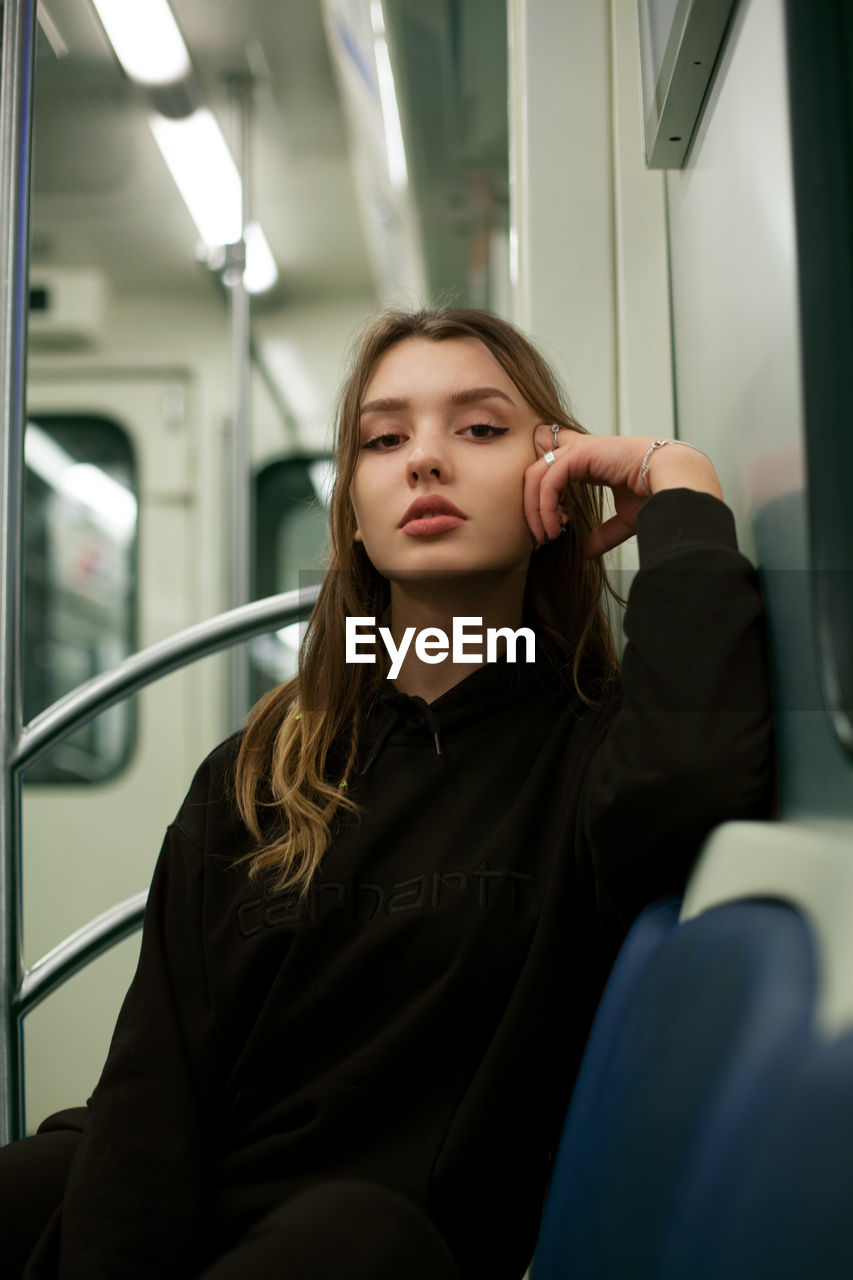 Portrait of young woman traveling in train