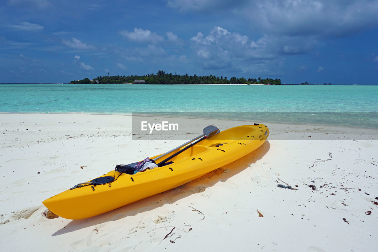 YELLOW BOAT ON BEACH