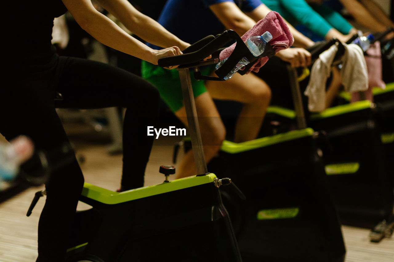 People using exercise bikes at gym