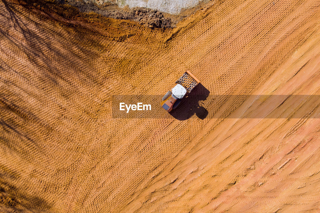 high angle view of man walking on sand at beach