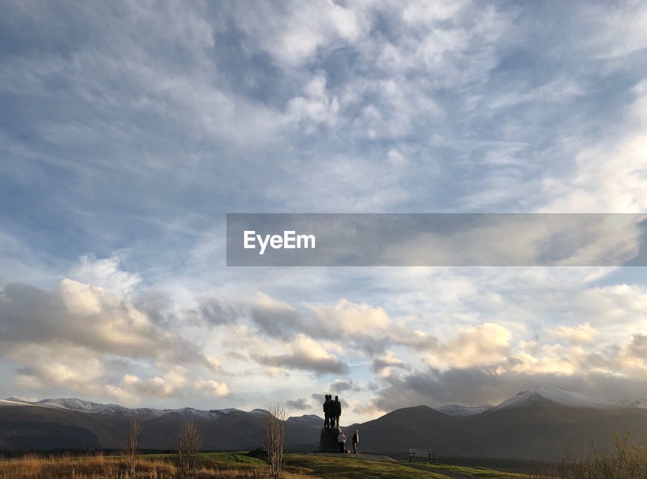 Man standing on landscape against sky