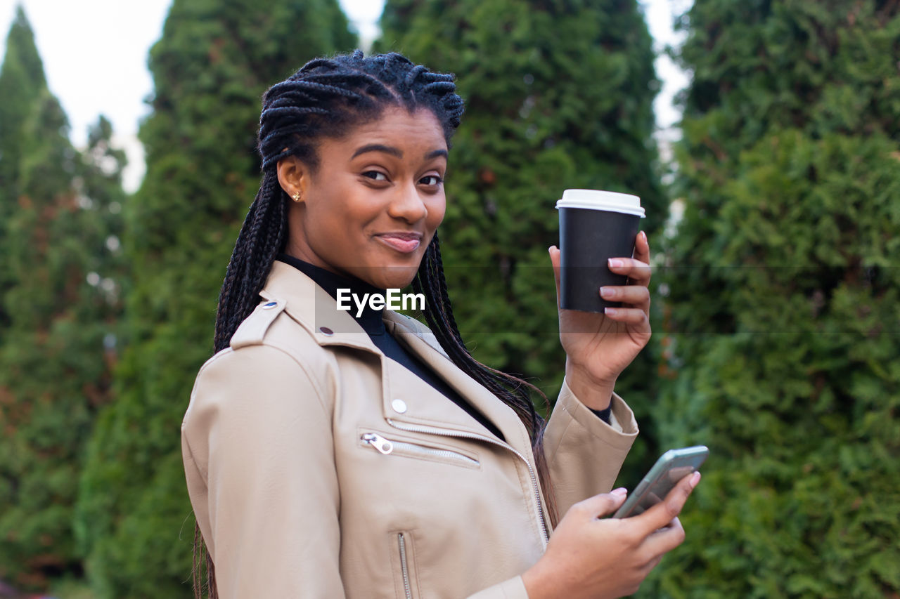 Portrait of young woman using mobile phone