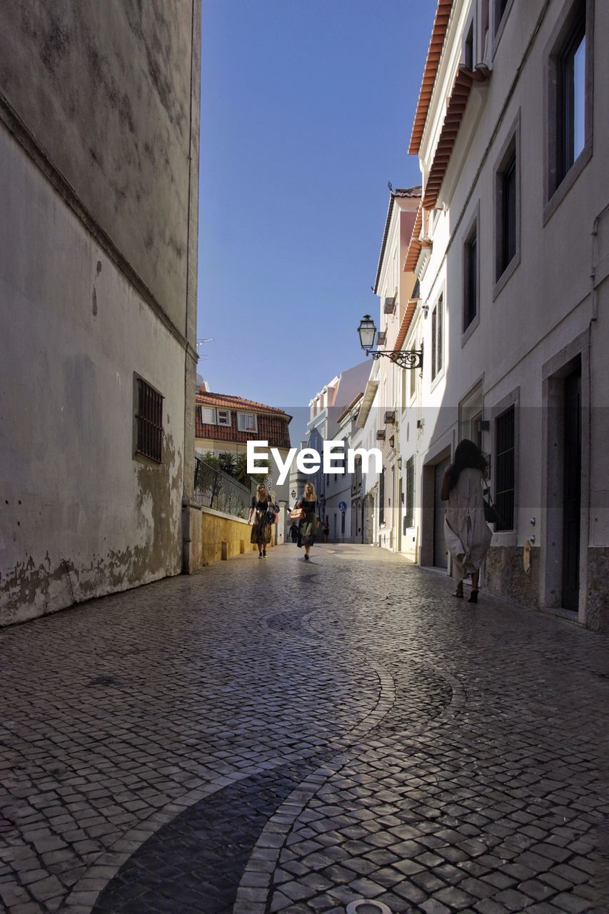 ALLEY AMIDST BUILDINGS IN TOWN