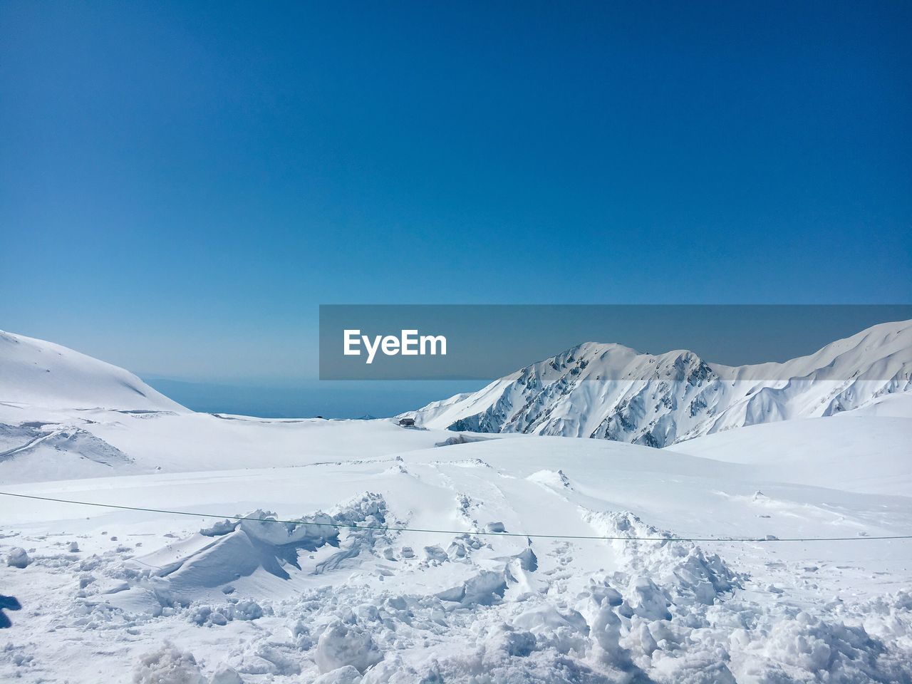 SNOWCAPPED MOUNTAIN AGAINST BLUE SKY