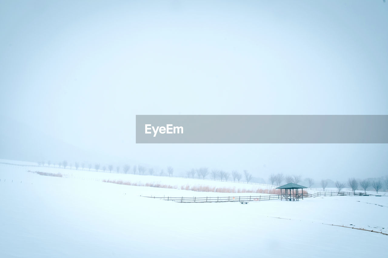 Frozen lake against clear sky