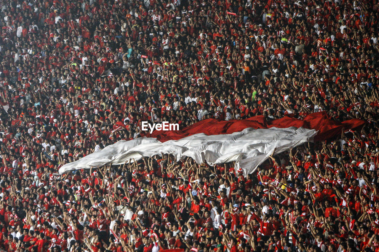 Full frame shot of crowded audience celebrating in stadium