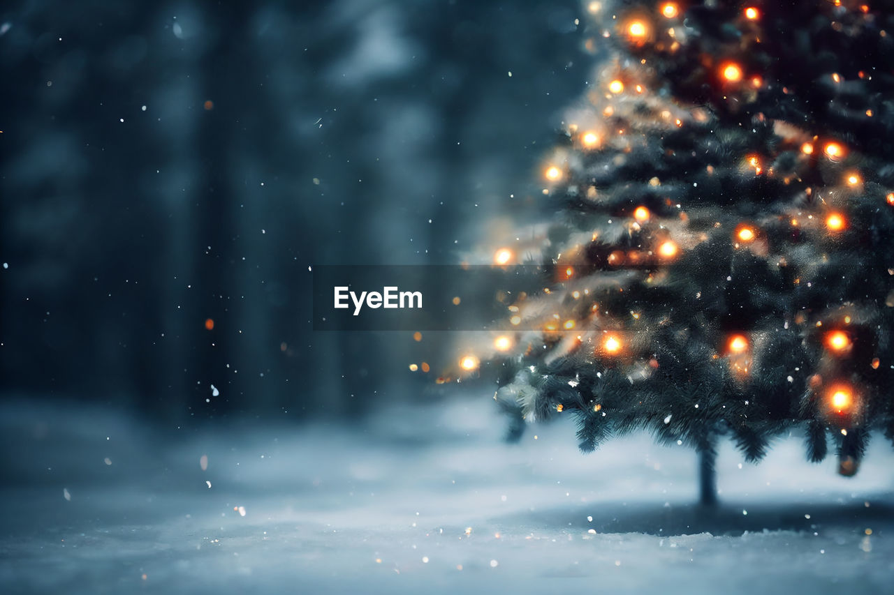 Abstract blurred bokeh background of christmas tree with snow at night