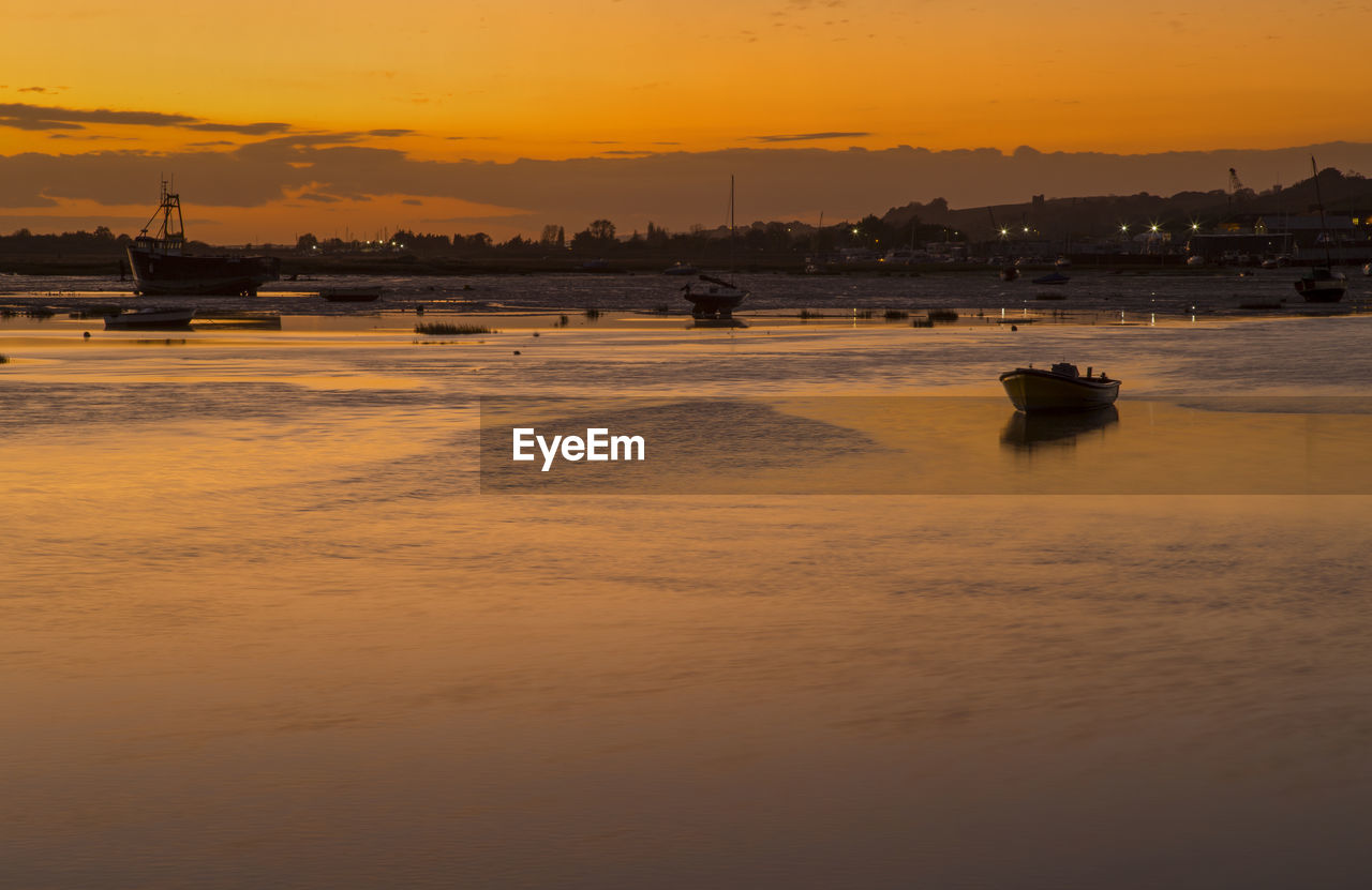 Scenic view of sea against orange sky