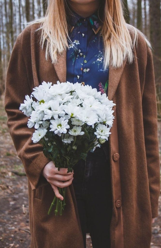 Close-up mid section of a woman holding bouquet outdoors