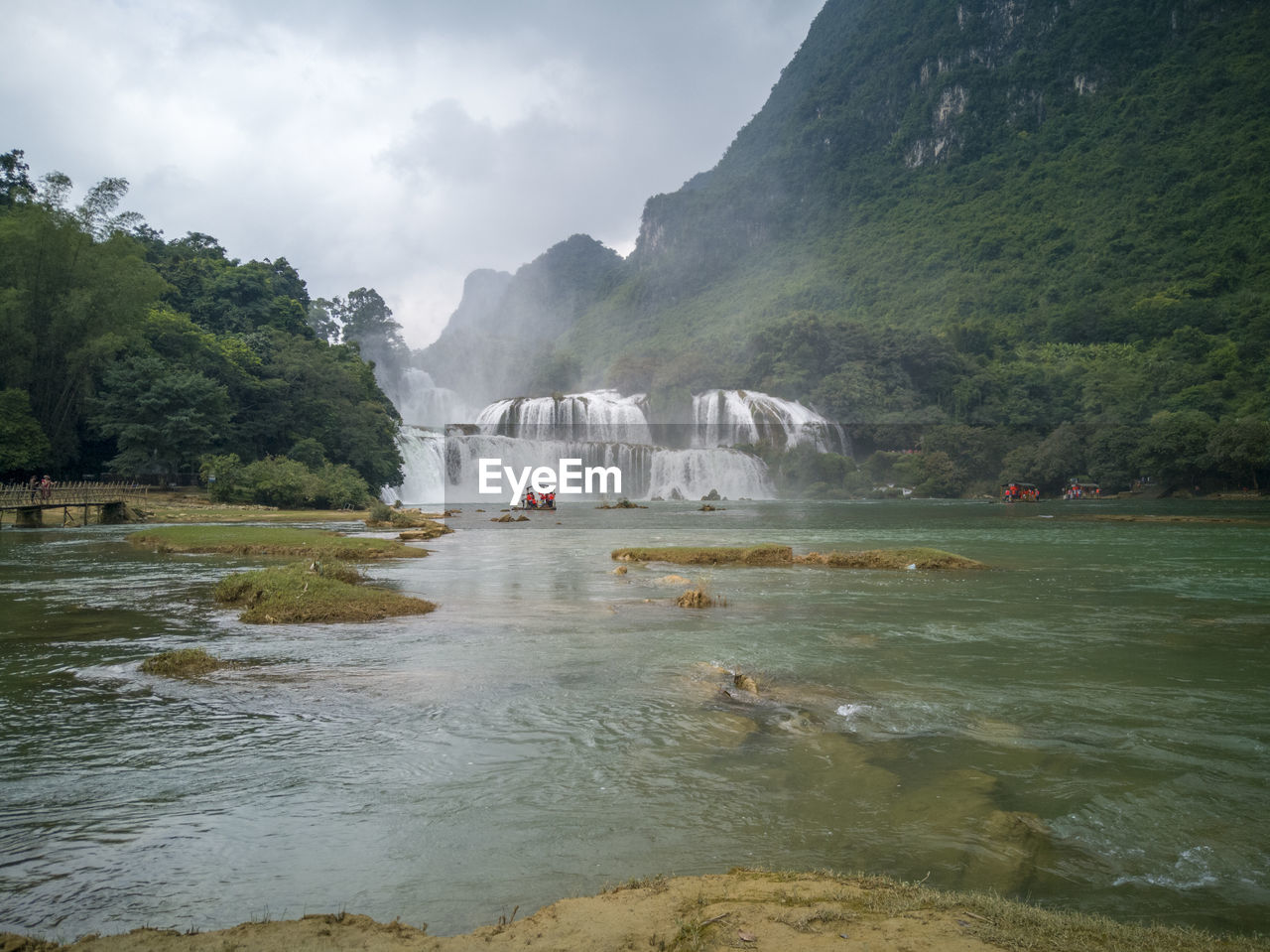 SCENIC VIEW OF RIVER FLOWING THROUGH MOUNTAINS