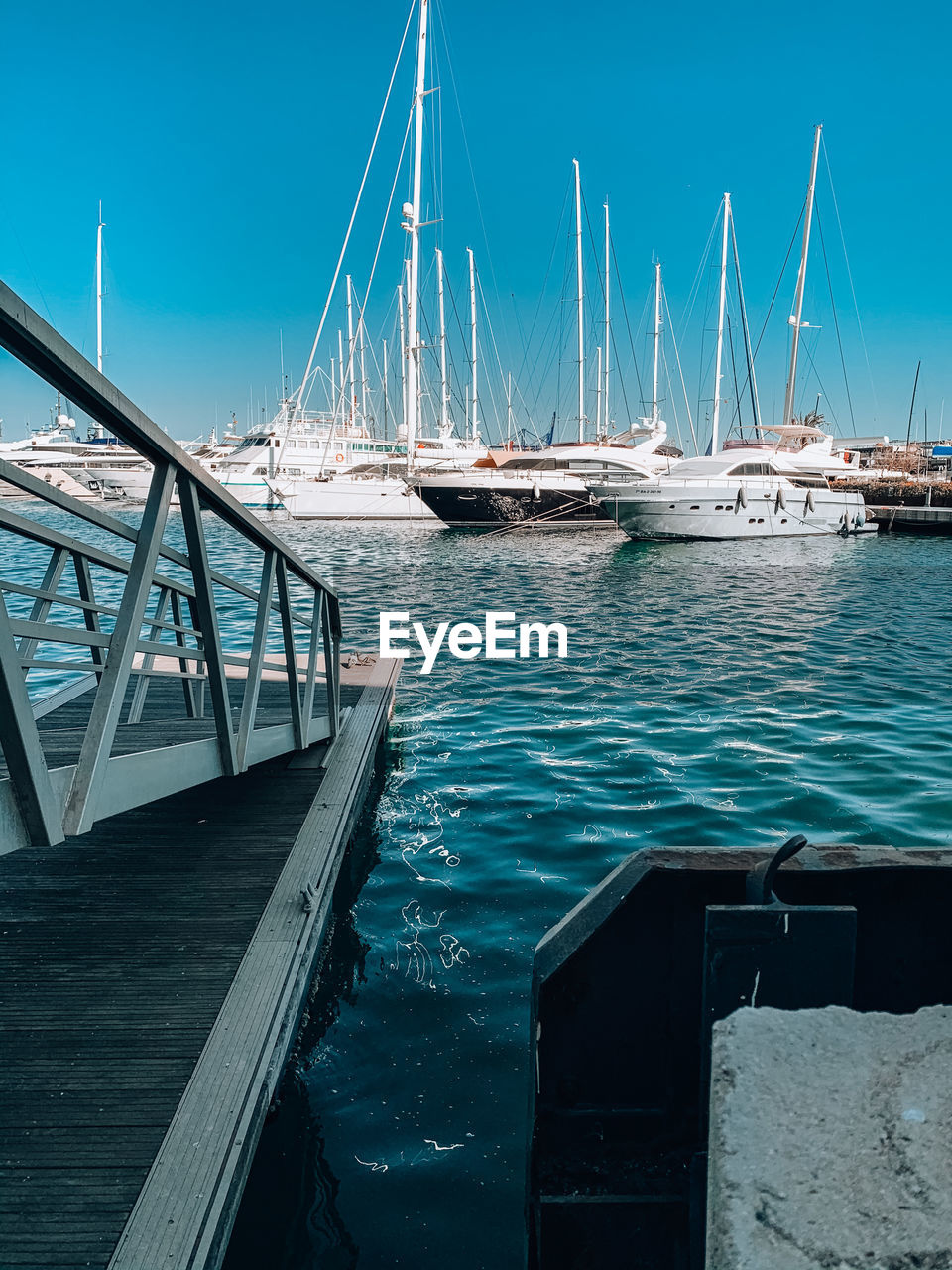 SAILBOATS MOORED IN SEA