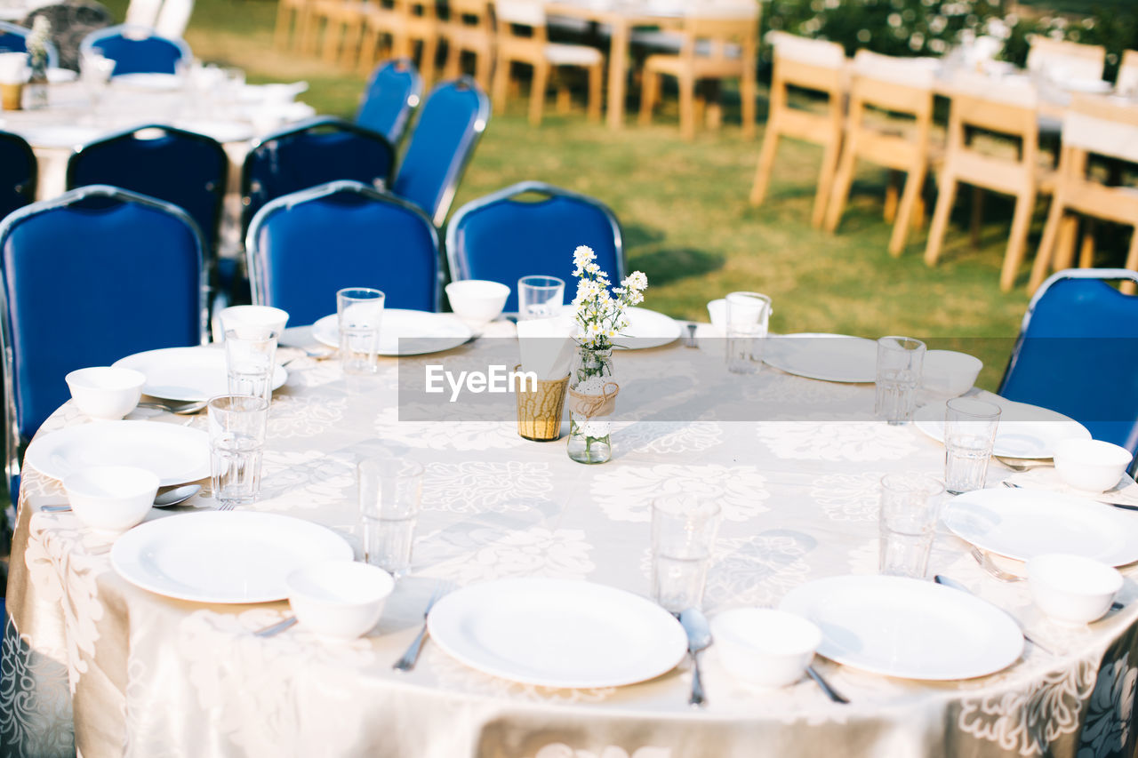 Plates and glasses arranged on table