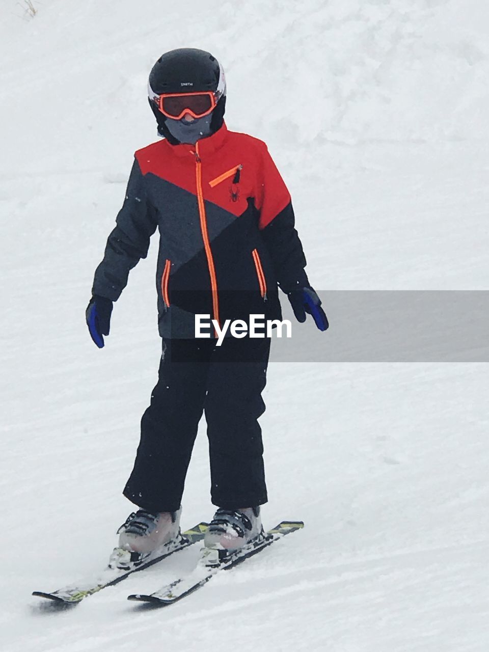 Full length of boy skiing