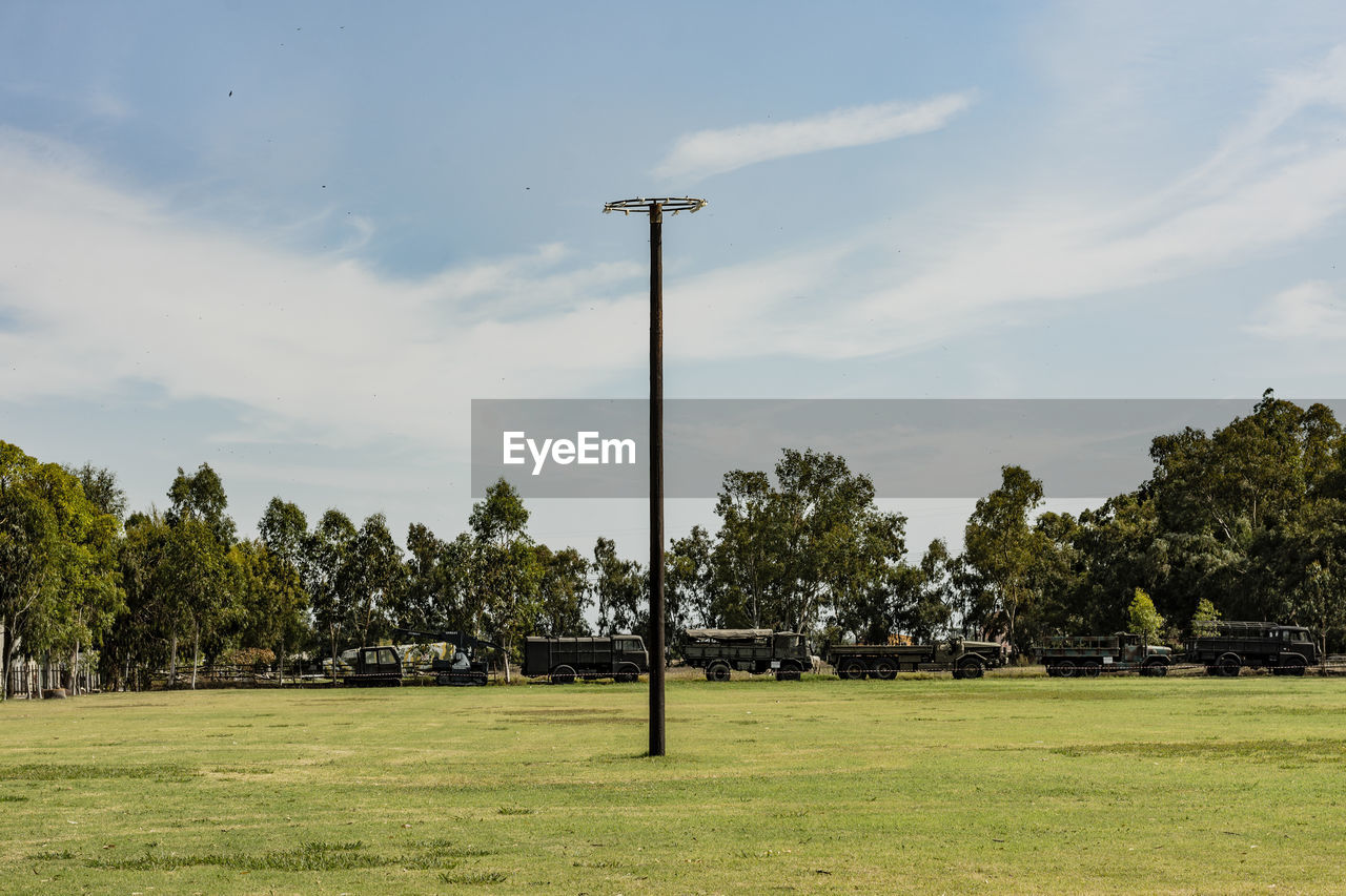 SCENIC VIEW OF TREES ON FIELD AGAINST SKY