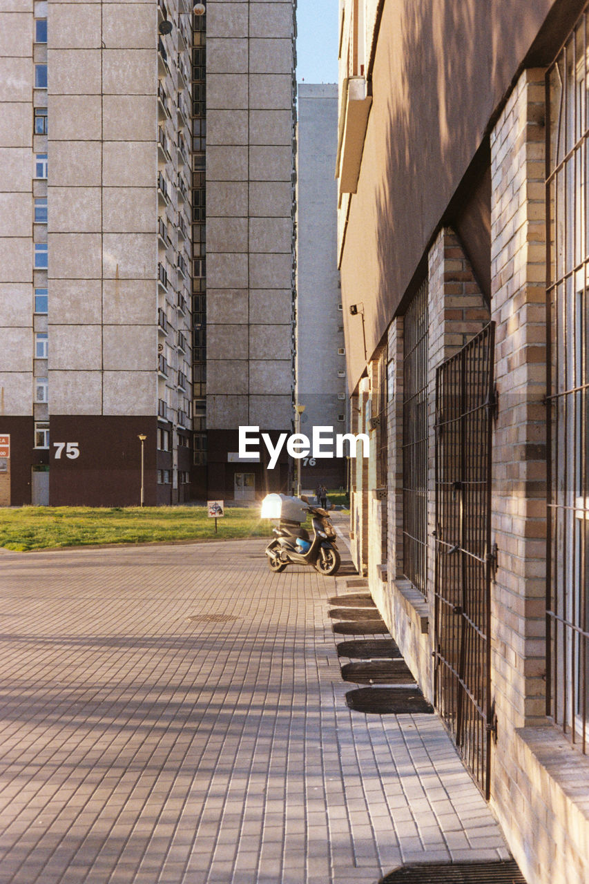 PEOPLE ON STREET AMIDST BUILDINGS IN CITY