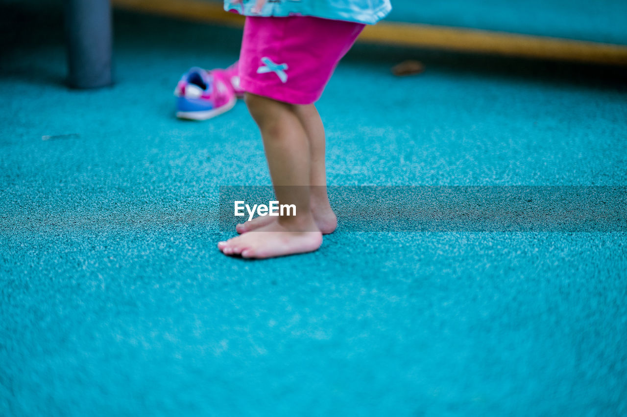 Low section of girl standing at playground