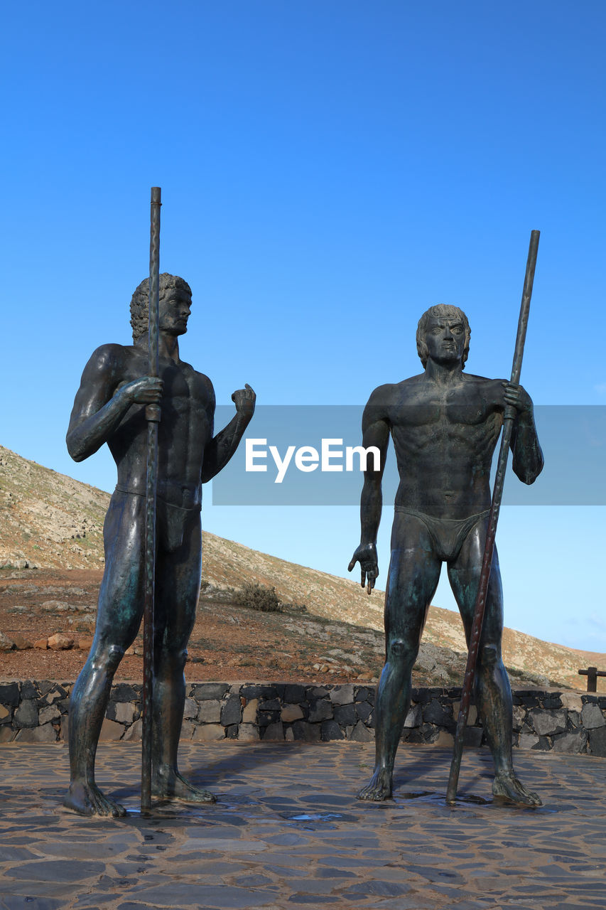 sculpture, monument, blue, sky, clear sky, statue, art, human representation, nature, representation, history, male likeness, the past, travel destinations, bronze sculpture, no people, architecture, travel, ancient history, day, outdoors, land