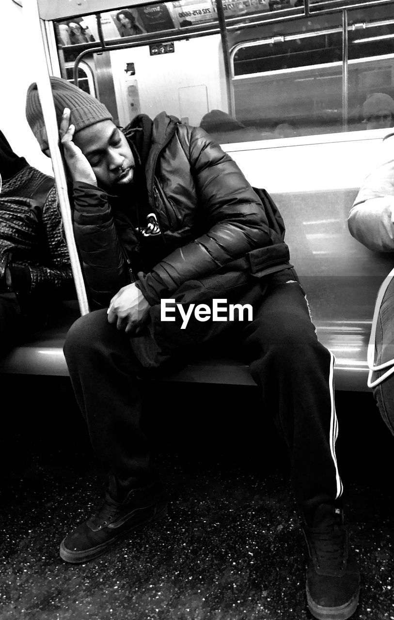 PEOPLE SITTING ON TRAIN