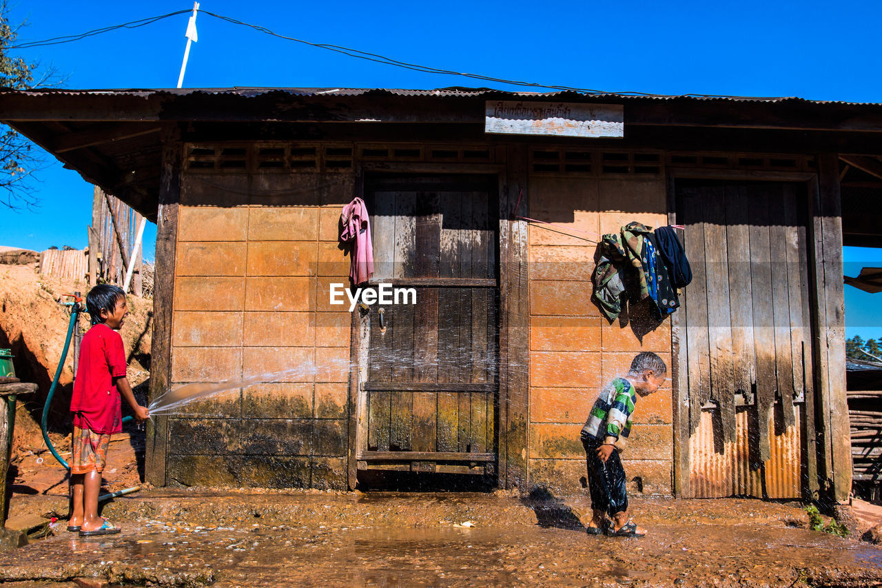 PEOPLE WALKING BY BUILDING